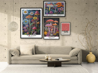 Four framed Yayoi Kusama prints with white borders above a beige sofa on a concrete wall
