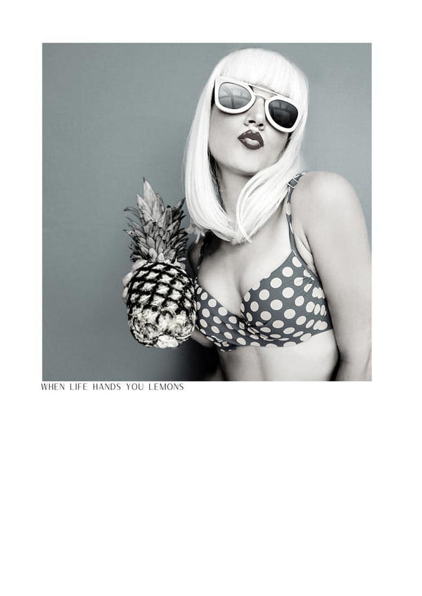 Woman in polka dot bikini holding pineapple, wearing sunglasses; "When life hands you lemons" poster.