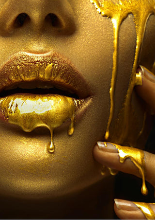 Close-up of golden lips and chin with gold liquid drips; modern fashion art poster design.