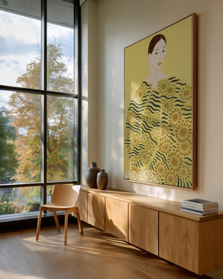 Yellow Hero by Martina Karlsson framed on a modern living room wall with natural wood furniture and large windows.