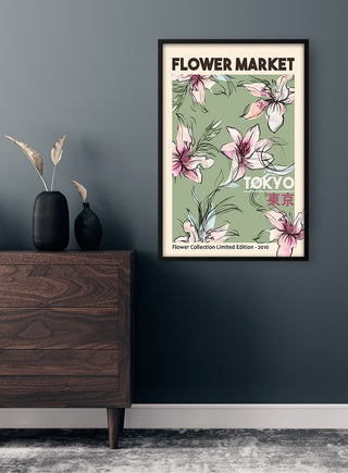 Framed "Flower Market Tokyo" poster with pink lilies on a green background, displayed above a dresser.