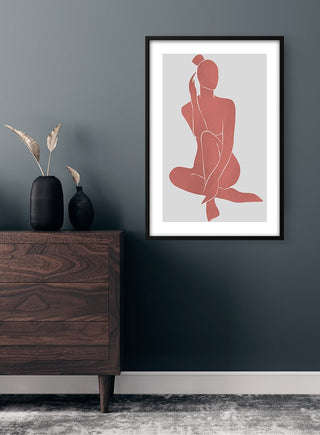 Abstractions in Red Plakat art print featuring a minimalist red figure on a gray background, framed above a wooden dresser.