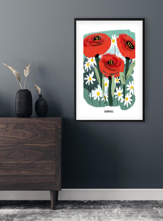 Framed Flowerbomb Poppies poster with red poppies and white daisies, displayed above a dark wood dresser.