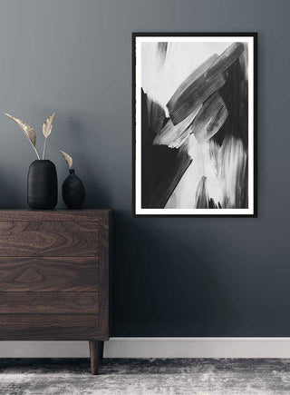 Abstract Strokes Black Plakat in black frame hangs on a gray wall above a wooden dresser with decorative vases.