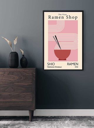 Framed "First Ramen Shop" plakat with minimalist ramen bowl art hanging on a modern gray wall.