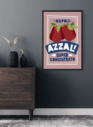 Framed Azzali Concentrato Plakat poster with tomatoes, displayed on a wall above a dark wood cabinet.