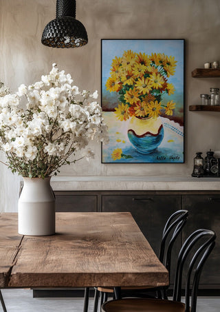 Yellow flowers by Nella Hajdu in a black frame above a rustic table with white flowers