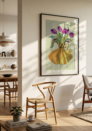 Lilac tulips by Marjorie Salvagni in a black frame in a bright dining room with wooden chairs