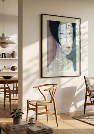 A Child by Designus in a black frame in a bright dining room with wooden chairs