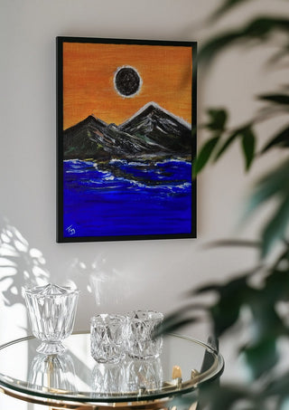 Overshadow by Fábio Diniz Art in a black frame above a glass table with crystal glassware