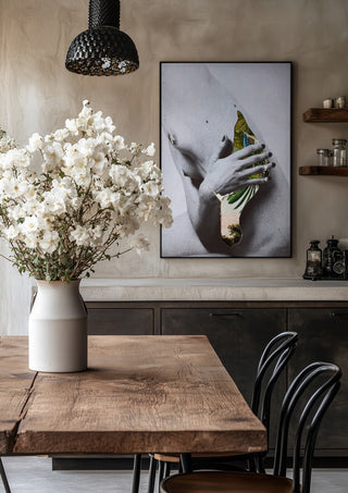Duermen los volátiles by Rocio Montoya in a black frame above a rustic table with white flowers