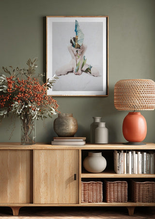 Letargo I by Rocio Montoya above a wooden sideboard on a sage green wall