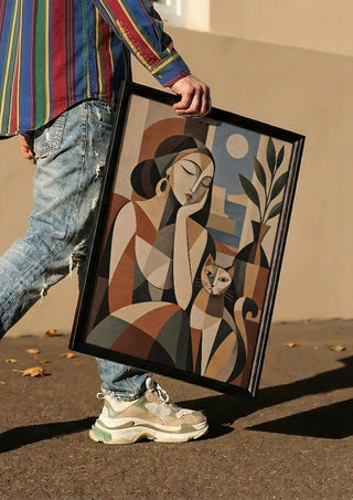 Geometric Woman & Cat – Earthy Cubist Harmony by TimlessArtworks carried in a black frame along a sunny street