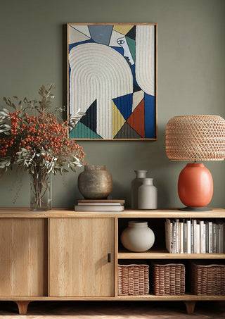 Ossacip by Art Guveau above a wooden sideboard on a sage green wall