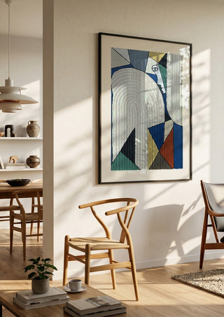 Ossacip by Art Guveau in a black frame in a bright dining room with wooden chairs