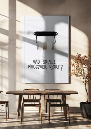 Vad skulle Macgyver gjort? by Grafik bageri hanging above a wooden dining table in warm sunlight