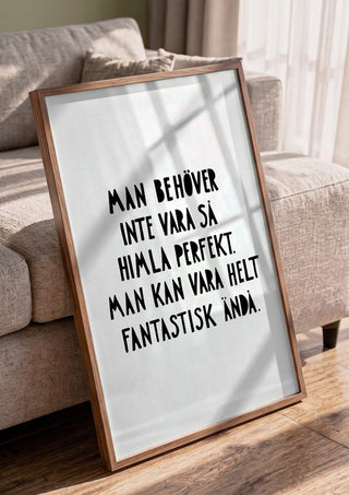 Fantastisk by Grafik bageri in a walnut frame leaning against a grey sofa