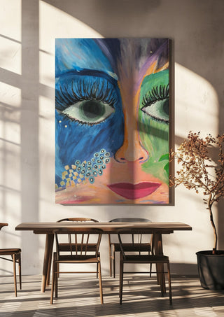 Blue and Green Face by Camilla Sabrina hanging above a wooden dining table in warm sunlight