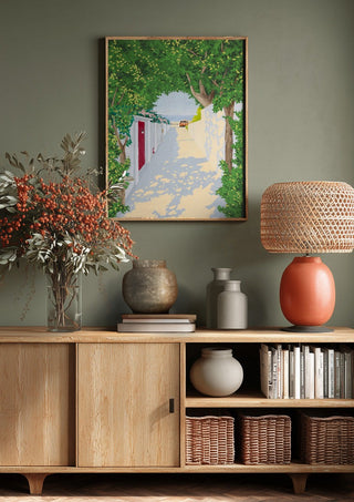 Story of light by Jaron Su above a wooden sideboard on a sage green wall