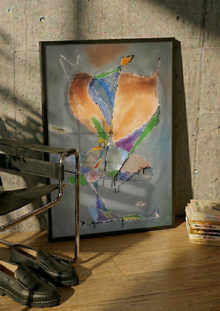 Butterfly by Art Guveau in a black frame leaning against a concrete wall by a steel chair