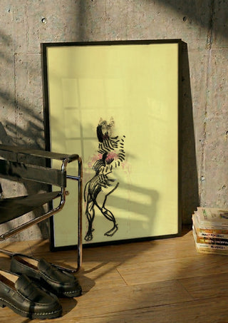 Gift by Alice Ruja in a black frame leaning against a concrete wall by a steel chair