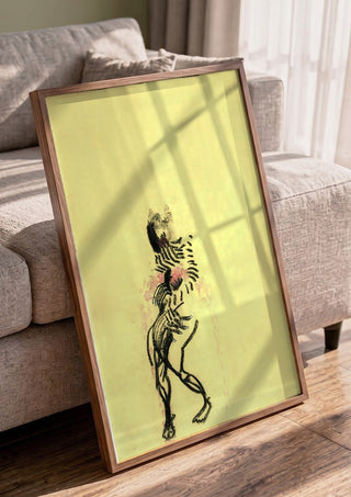 Gift by Alice Ruja in a walnut frame leaning against a grey sofa