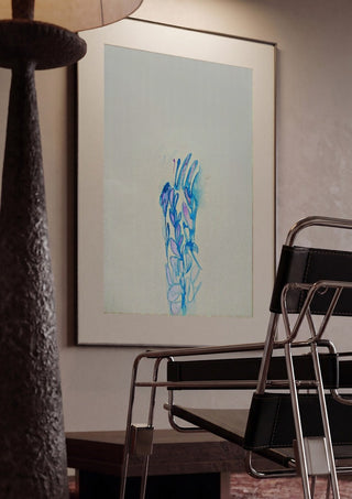 Blue ChrysAlice by Alice Ruja framed in a dim room beside a tubular steel chair