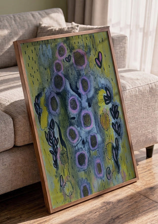Summer rain by Alice Ruja in a walnut frame leaning against a grey sofa