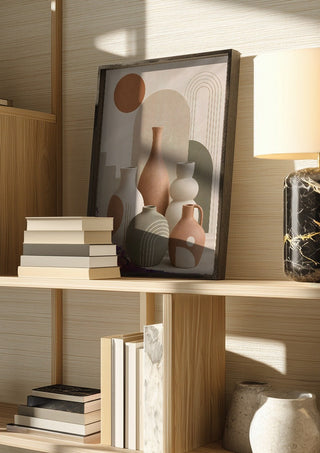 Boho Ceramic Vases & Botanical Abstract Design – Terracotta Sun by TimlessArtworks in a dark frame on a wooden shelf beside books and a lamp