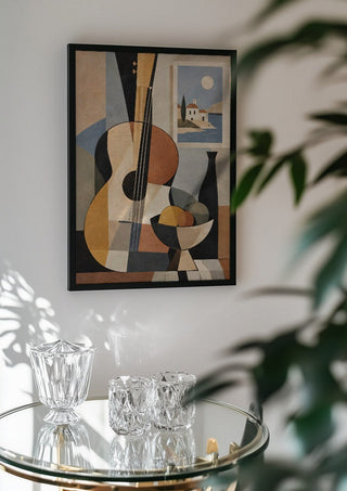 Bohemian String Instrument Still Life – Earthy Tones & Coastal Scene by TimlessArtworks in a black frame above a glass table with crystal glassware
