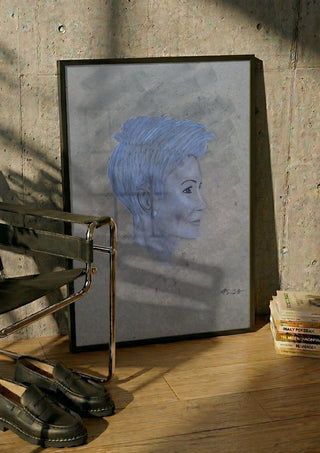 Portrait in Blue by Allheartsportraits in a black frame leaning against a concrete wall by a steel chair