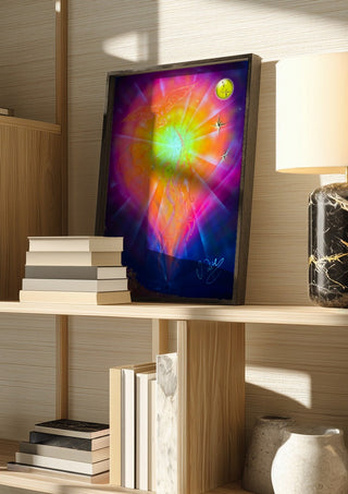 Zodiac Sign Sagittarius by Walter Zettl in a dark frame on a wooden shelf beside books and a lamp