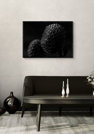 Lunar Bloom II by Guido Lucker in a black frame above a dark sofa with candlesticks and a vase