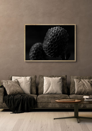 Lunar Bloom II by Guido Lucker framed in light wood above a grey sofa with cushions