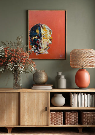 Head in Colour by René J above a wooden sideboard on a sage green wall