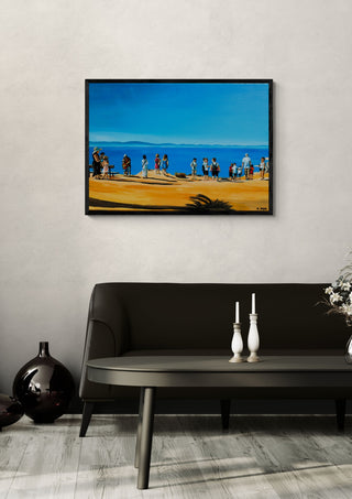 Above Rhodes Town by Nella Hajdu in a black frame above a dark sofa with candlesticks and a vase