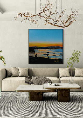 Last Rays by Nella Hajdu in a black frame above a beige sofa under a branch chandelier