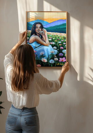 Where Wildflowers Dream by Nella Hajdu being hung on a sunlit wall