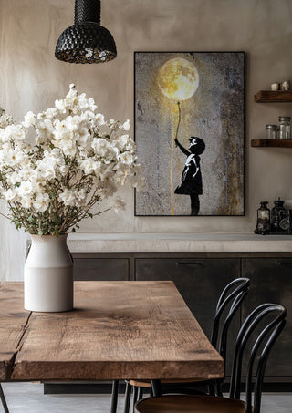Moon Balloon by Decker Studios in a black frame above a rustic table with white flowers