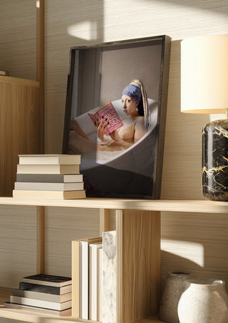 Chillin Time by Dikhotomy in a dark frame on a wooden shelf beside books and a lamp