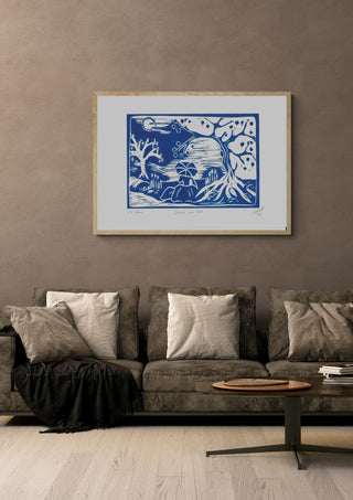 Dame am See · Lady by the Lake by ELIZA Leopold in a light wood frame above a grey sofa with cushions