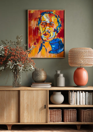 Man in a Blue Hat by René J above a wooden sideboard on a sage green wall