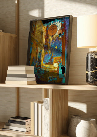 Mikro Cafe by Pelecan Schneider in a dark frame on a wooden shelf beside books and a lamp