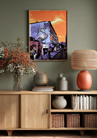 Brick Lane Pelican by Pelecan Schneider above a wooden sideboard on a sage green wall