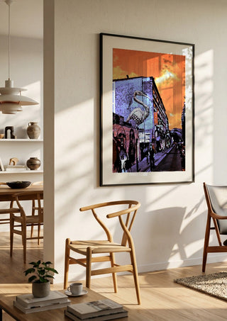 Brick Lane Pelican by Pelecan Schneider in a black frame in a bright dining room with wooden chairs