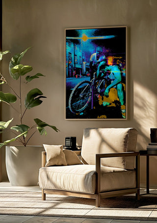 Bike Boys by Pelecan Schneider framed above a beige armchair beside a potted plant