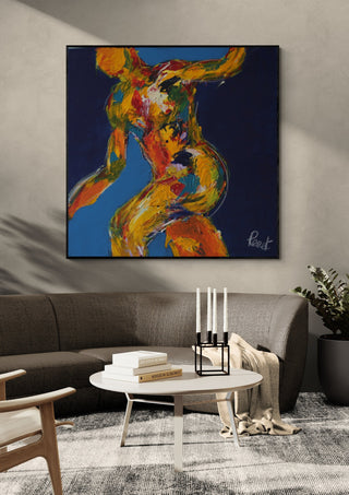 Dancer on Blue by René J in a black frame above a grey sofa with a round coffee table and candlesticks