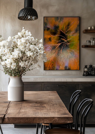 Copper Branches by Da Winters in a black frame above a rustic table with white flowers