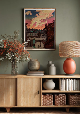 Evening walk by Nina Broen above a wooden sideboard on a sage green wall