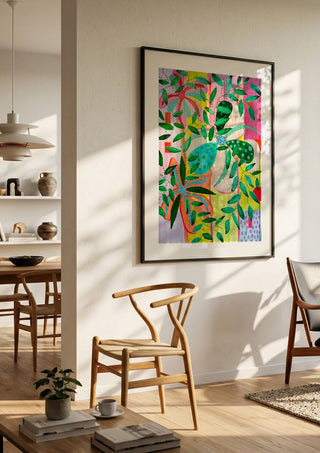 Bloom by LGDyrby in a black frame in a bright dining room with wooden chairs